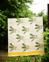 Block printed cotton waffle towel with frangipani or champa flowers in yellow and green