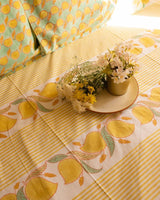 Details of a mango themed block printed Jaipuri Razai in pastel shades of yellow and green with mangoes and stripes