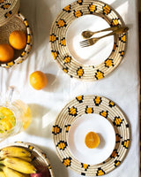 Leopard print Sabai grass placemats in a table setting with fruits