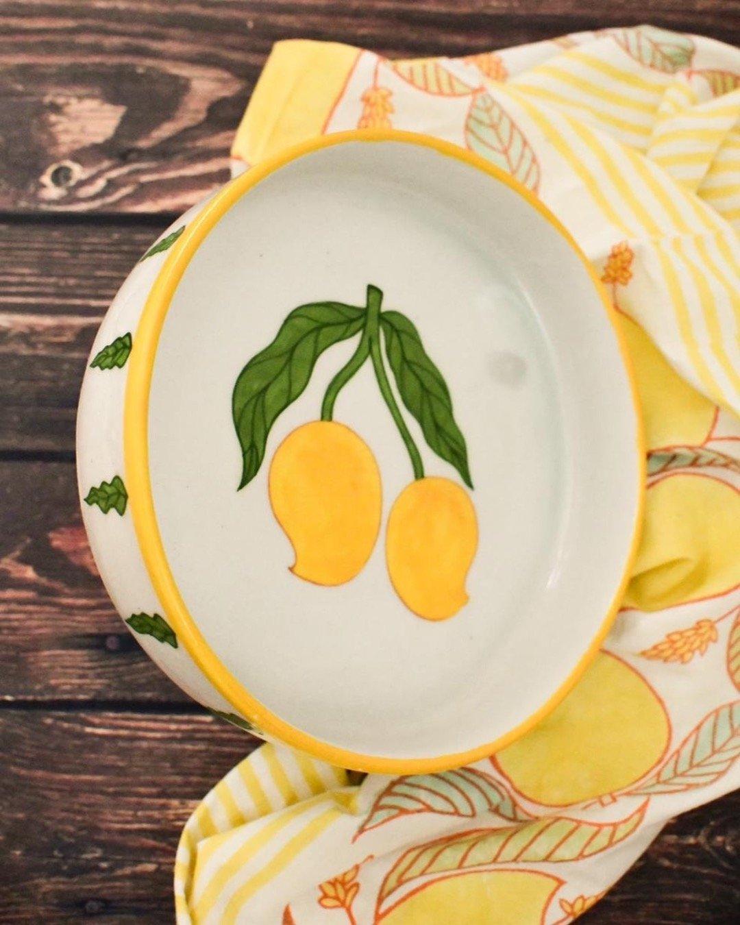Handmade pasta plate in Jaipuri pottery handpainted with mangoes in the centre and mango leaves painted on the sides.
