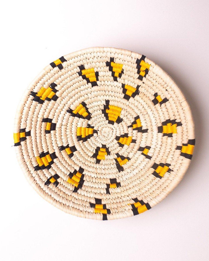 Leopard print handwoven Sabai grass wall plate or basket with yellow and black threadwork