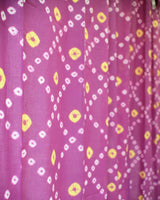 Details of purple and yellow bandhani fabric or curtain