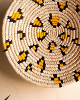 Leopard print Sabai grass wall plate or basket with yellow and black threadwork
