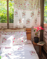 Apple themed bed sheet, pillow covers, and curtains in a room
