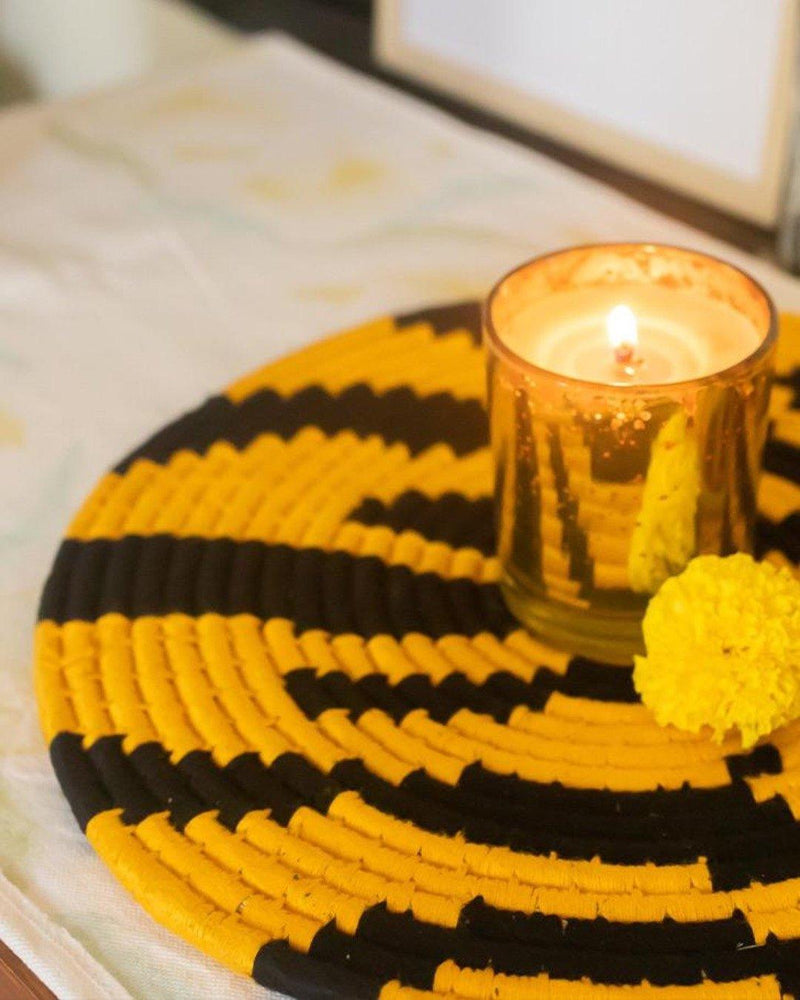 Tiger stripe print Sabai placemat with gold candle votive and a marigold