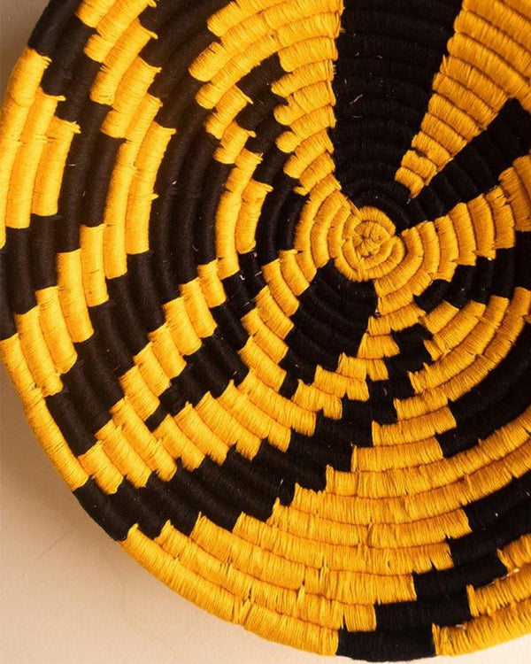 Tiger print Sabai grass wall plate or basket with yellow and black threadwork
